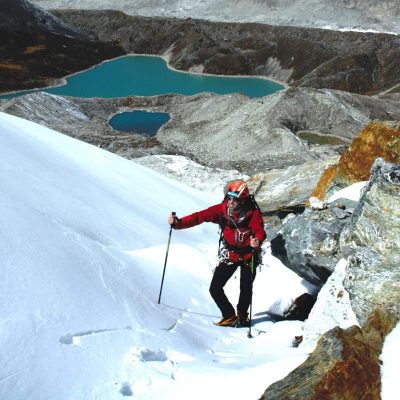 Mountaineer using Fizan trekking poles at altitude.